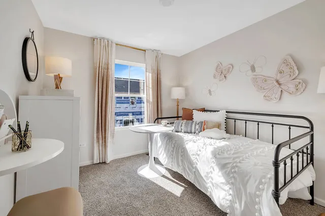 a bed room with a bed and a chair