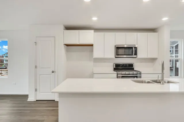 a kitchen with appliances a sink and cabinets