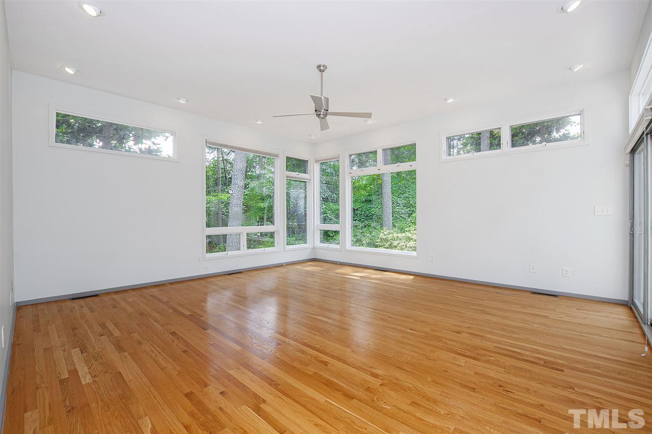 3405 Cherry Lane Raleigh, NC 27607 - Photo 11 of 18 a view of an empty room with wooden floor and a window