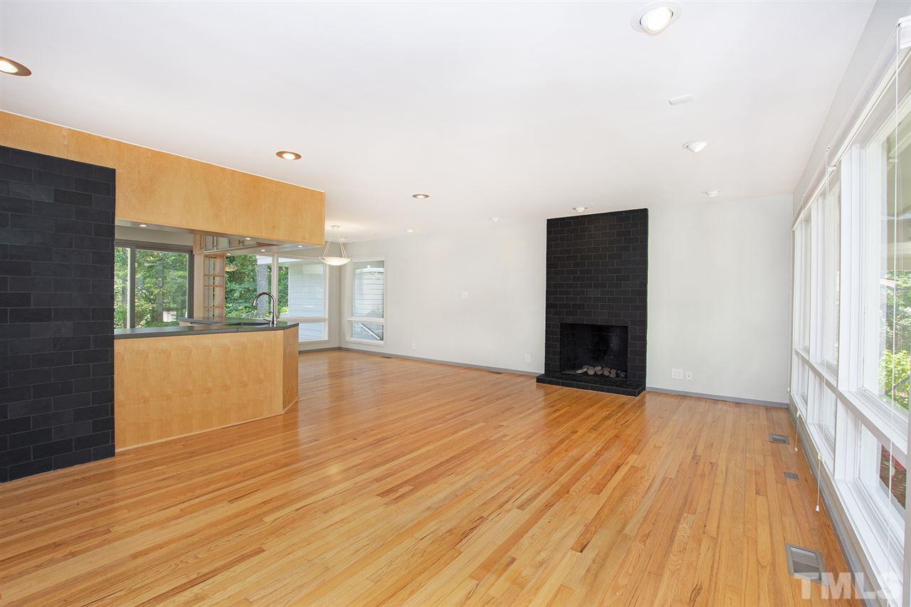 3405 Cherry Lane Raleigh, NC 27607 - Photo 6 of 18 a view of empty room with wooden floor and fireplace