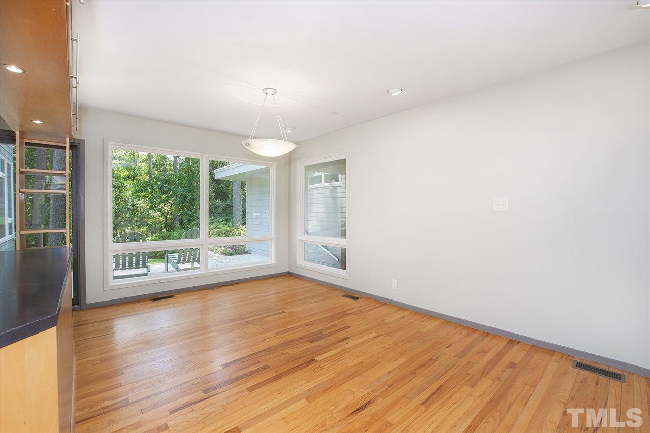3405 Cherry Lane Raleigh, NC 27607 - Photo 7 of 18 a view of an empty room with wooden floor and a window
