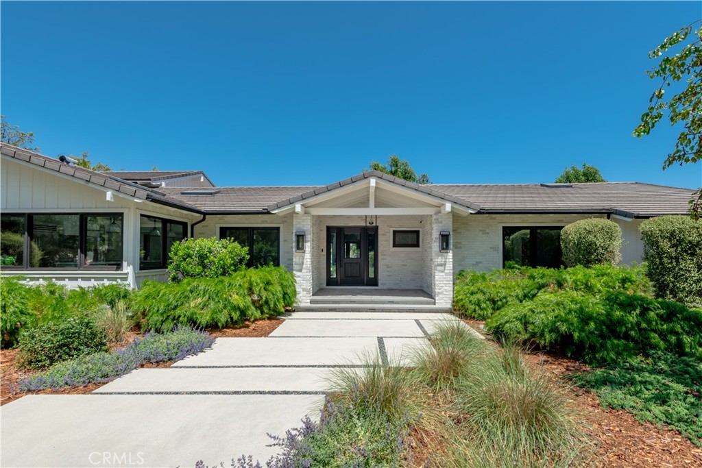 24884 Jim Bridger Road Hidden Hills, CA 91302 - Photo 2 of 31 a front view of a house with garden