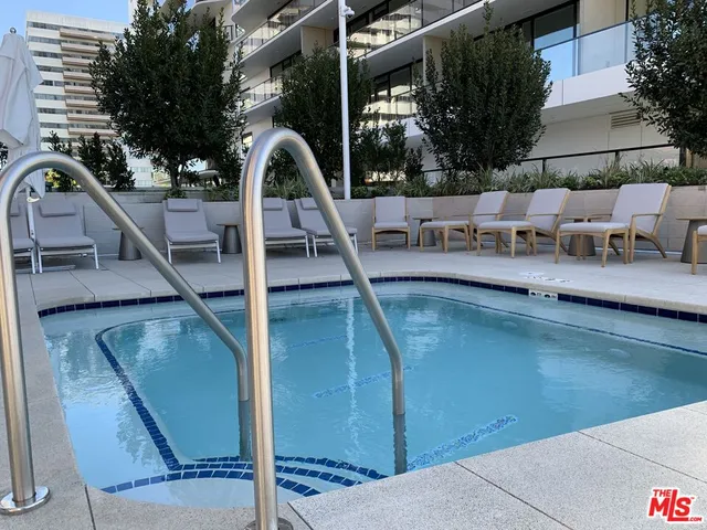 a view of a swimming pool with seating space