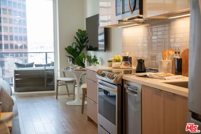 a kitchen with appliances cabinets and a table