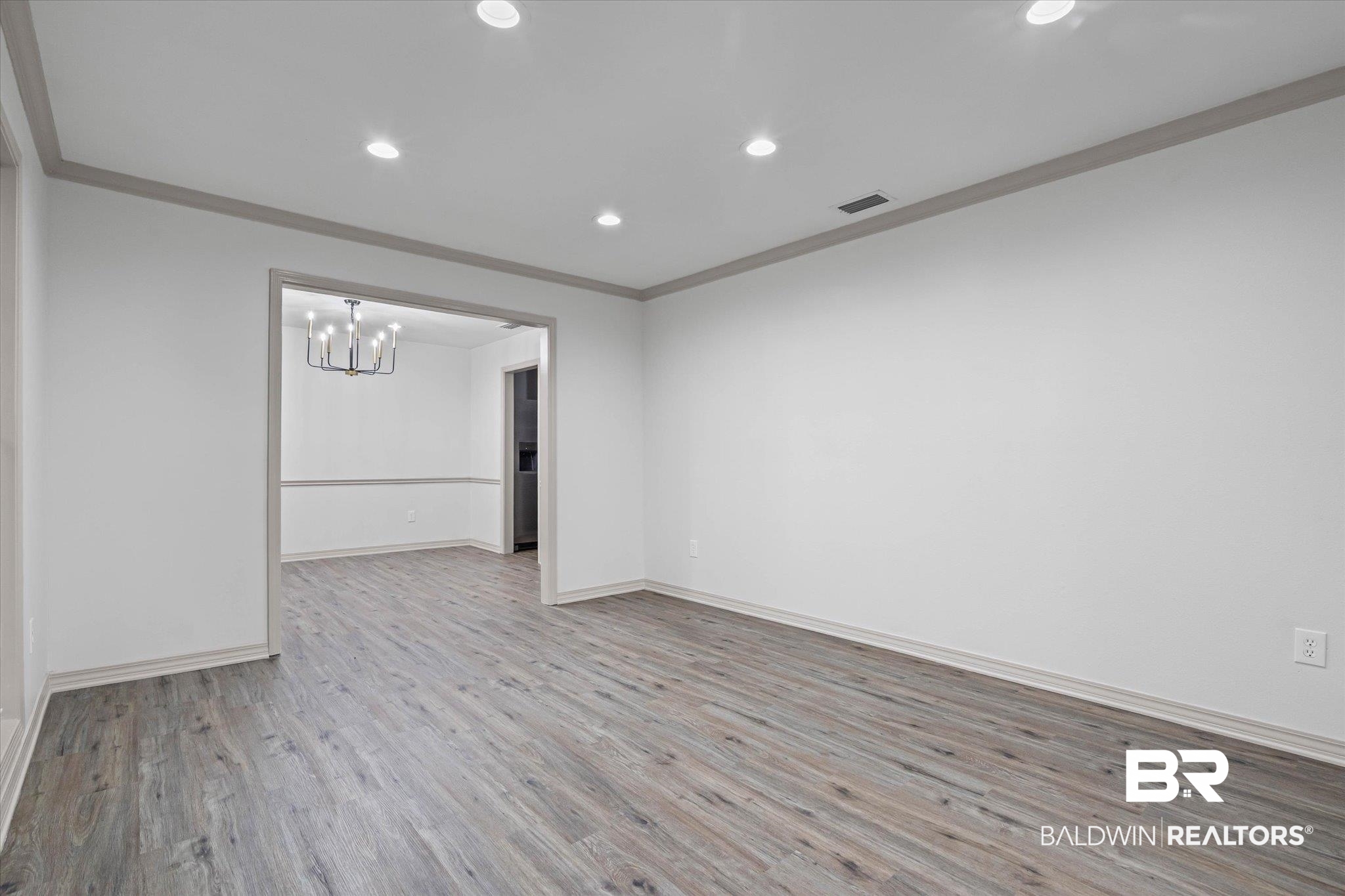 3655 Claridge Road South Mobile, AL 36608 - Photo 4 of 32 Unfurnished room with crown molding, light wood-type flooring, recessed lighting, and a chandelier