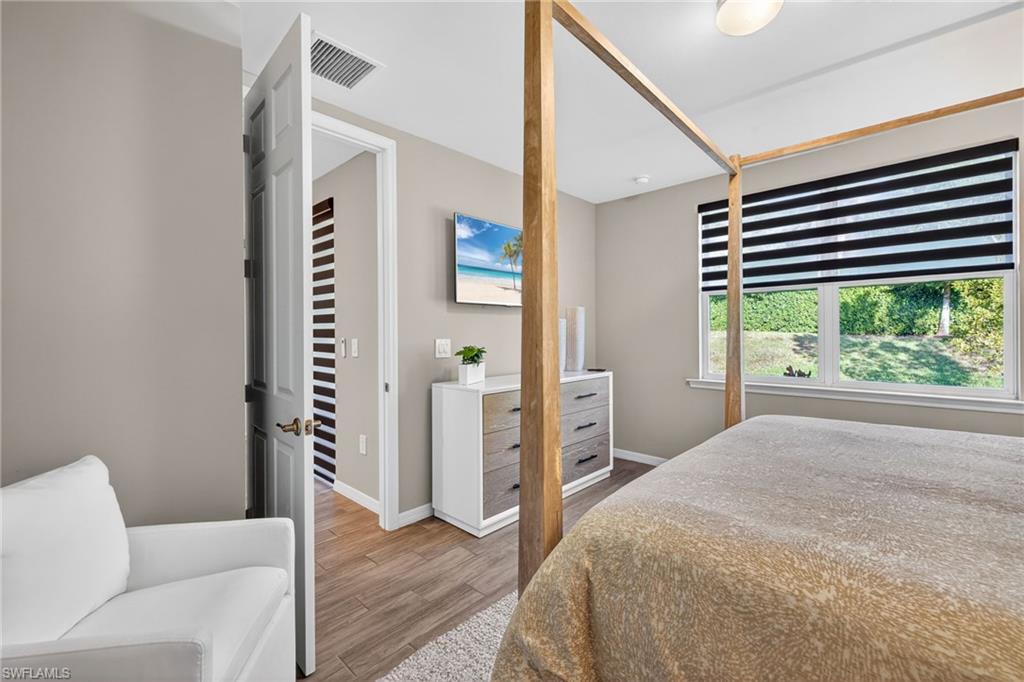 14567 Edgewater Circle Naples, FL 34114 - Photo 17 of 43 a bedroom with furniture and a window