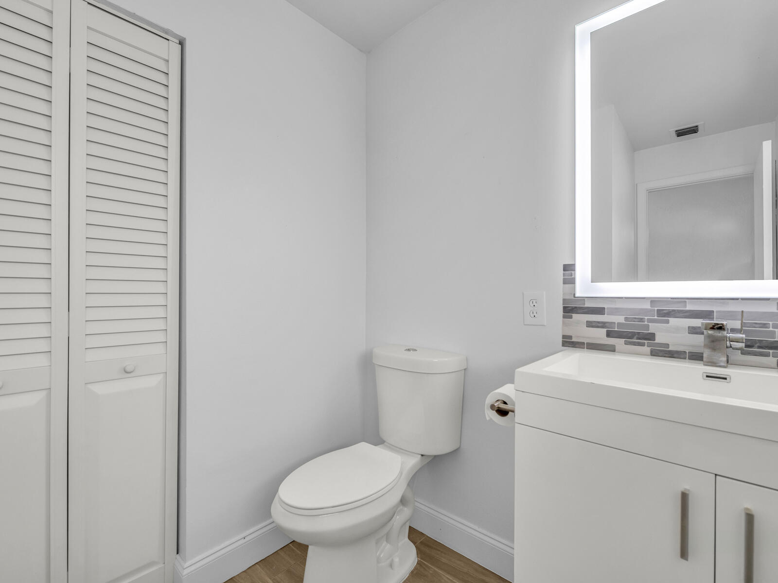 3001 Linton Boulevard, Unit 206C Delray Beach, FL 33445 - Photo 22 of 27 a bathroom with a toilet sink and mirror