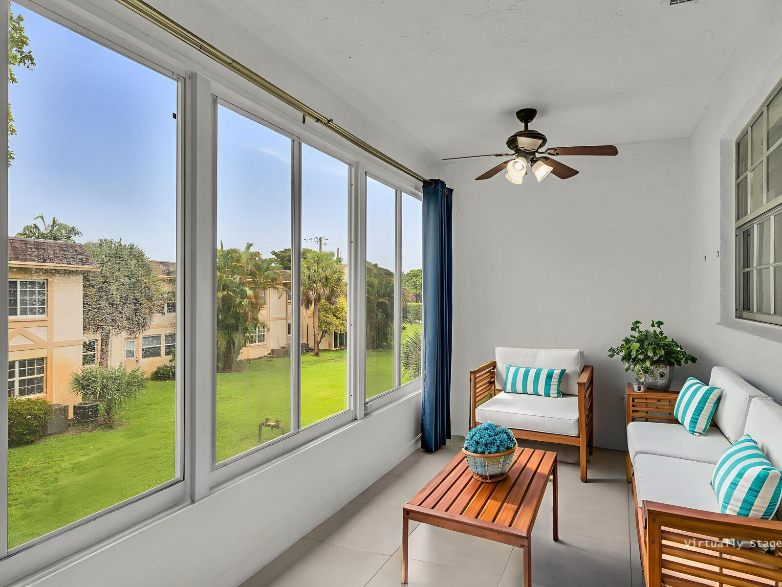 3001 Linton Boulevard, Unit 206C Delray Beach, FL 33445 - Photo 23 of 27 a living room with furniture and a floor to ceiling window