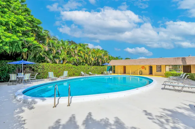 an outdoor space with swimming pool and furniture