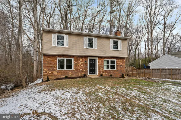 a view of a house with a yard covered in snow