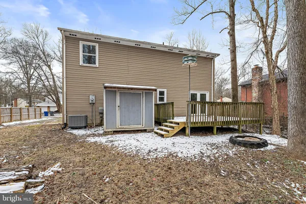 a view of a house with a small yard and wooden fence