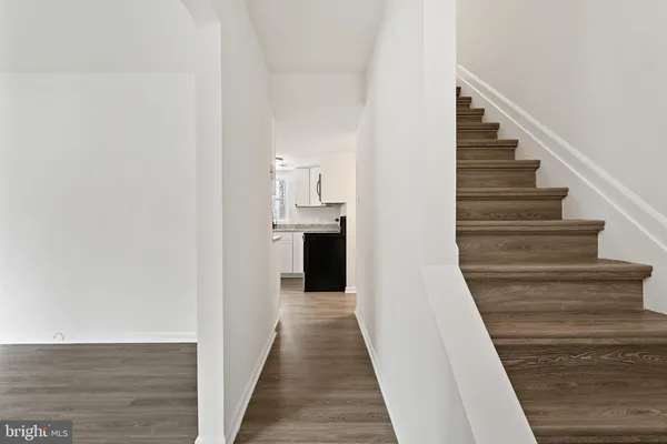 a view of empty room with wooden floor and fireplace