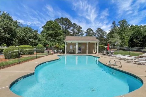 a view of house with outdoor space and swimming pool