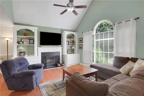 a living room with furniture a fireplace and a flat screen tv