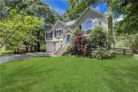 a front view of house with yard and green space