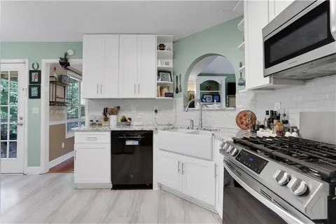 a kitchen with stainless steel appliances granite countertop a stove and a refrigerator