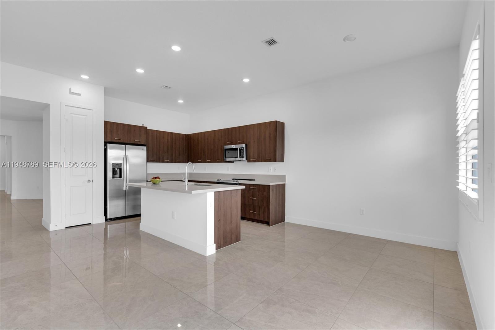 4538 Southwest 173rd Avenue Miramar, FL 33029 - Photo 13 of 48 a large kitchen with stainless steel appliances a large counter top and a stove top oven