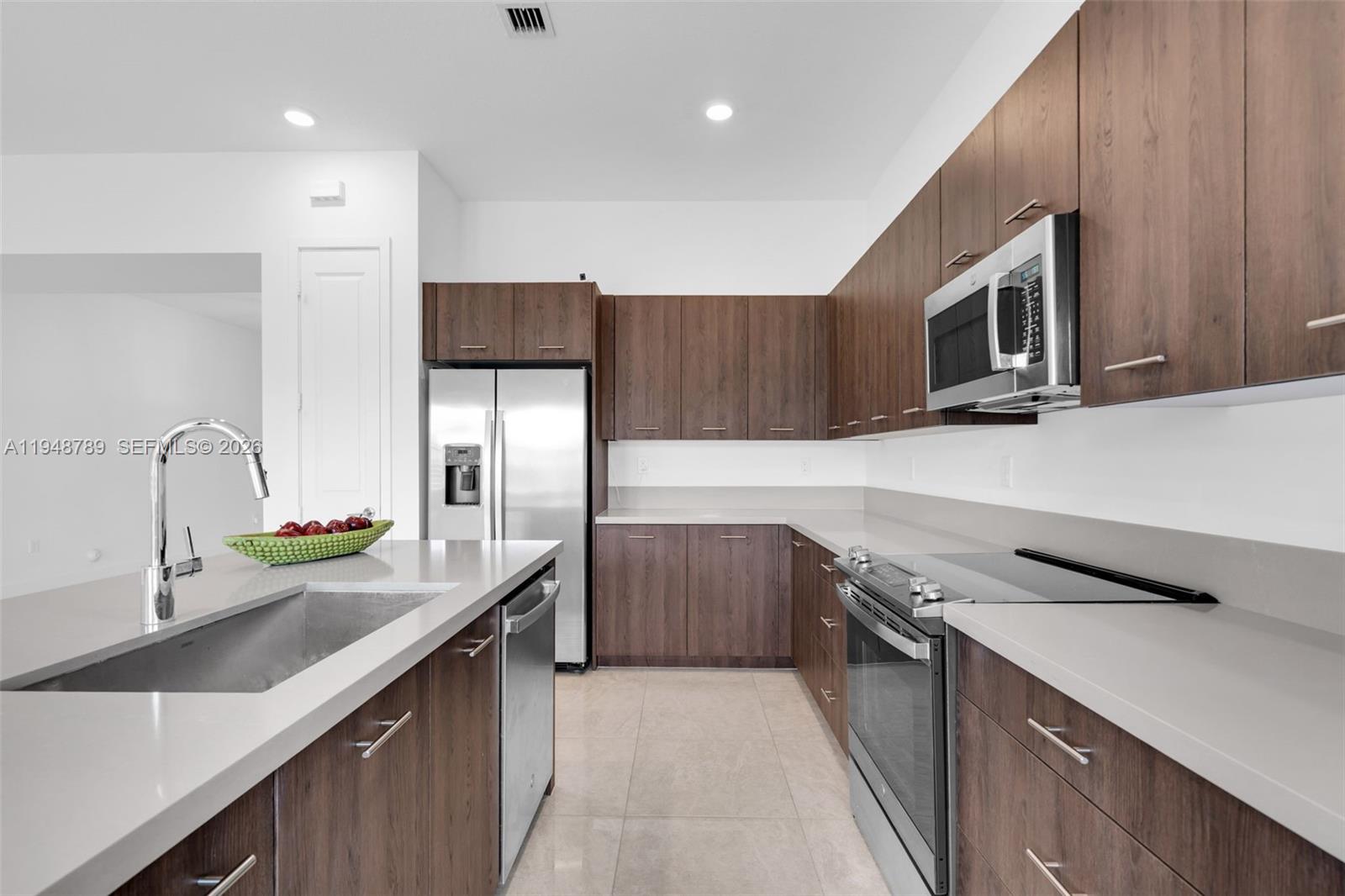 4538 Southwest 173rd Avenue Miramar, FL 33029 - Photo 14 of 48 a kitchen with a sink and a stove top oven