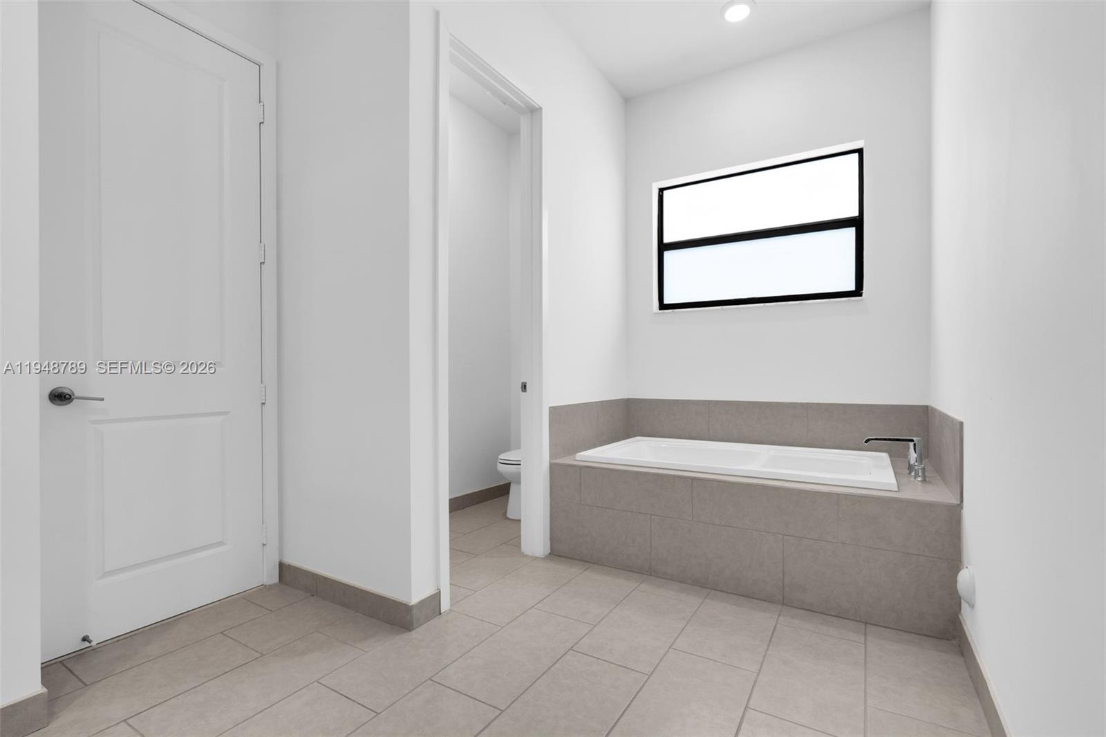 4538 Southwest 173rd Avenue Miramar, FL 33029 - Photo 22 of 48 a bathroom with a bathtub and window