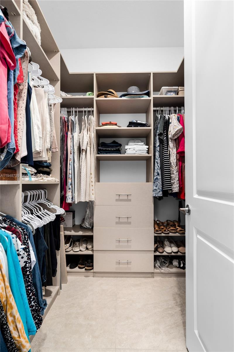 4538 Southwest 173rd Avenue Miramar, FL 33029 - Photo 25 of 48 a view of walk in closet with clothes and shoes