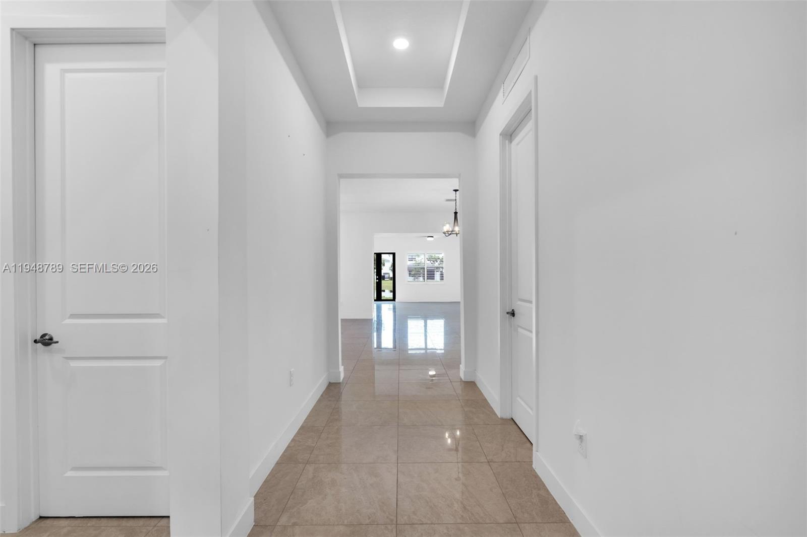 4538 Southwest 173rd Avenue Miramar, FL 33029 - Photo 3 of 48 a view of a hallway with wooden floor and a bathroom