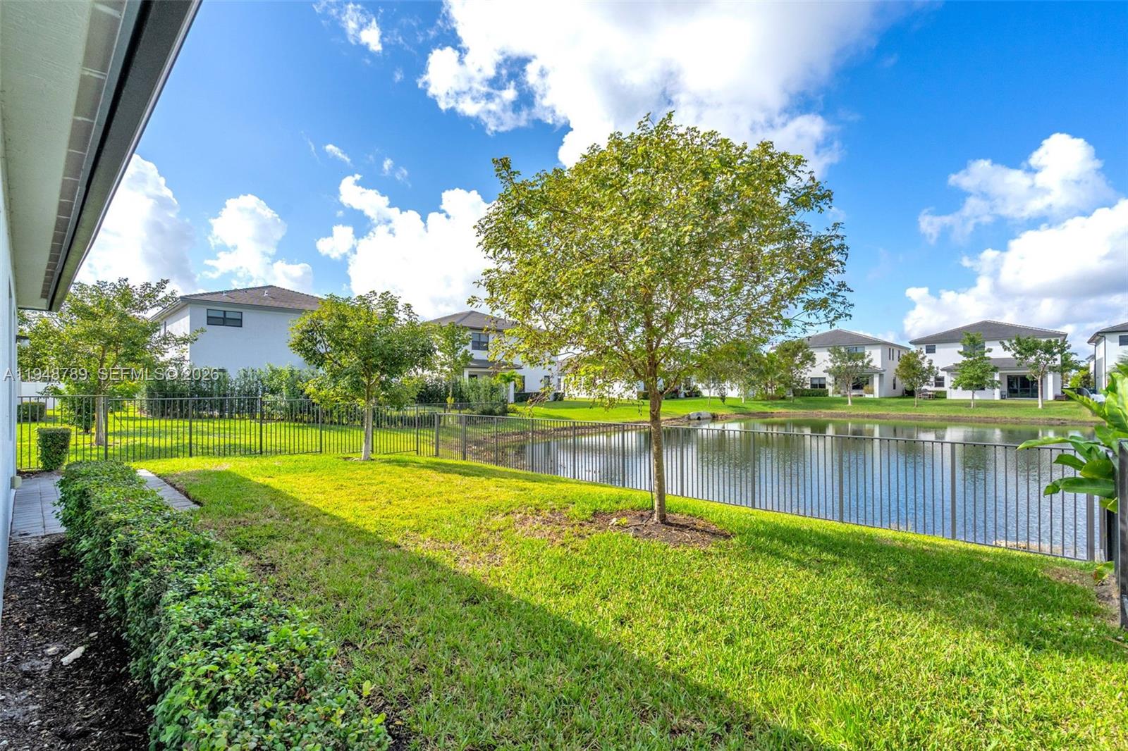 4538 Southwest 173rd Avenue Miramar, FL 33029 - Photo 38 of 48 a view of a lake with a house in the background