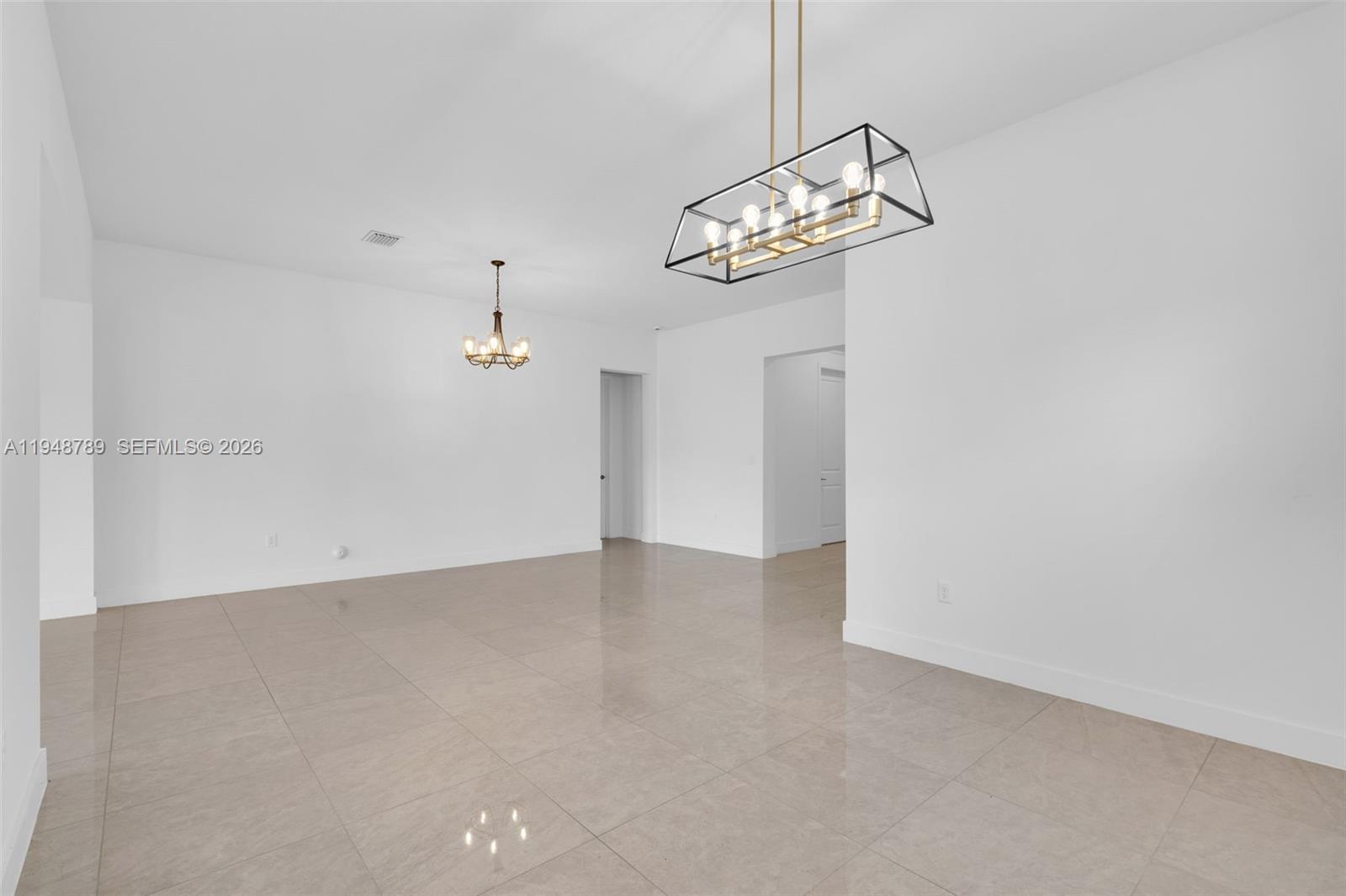 4538 Southwest 173rd Avenue Miramar, FL 33029 - Photo 8 of 48 a view of a room with a hanging light and kitchen