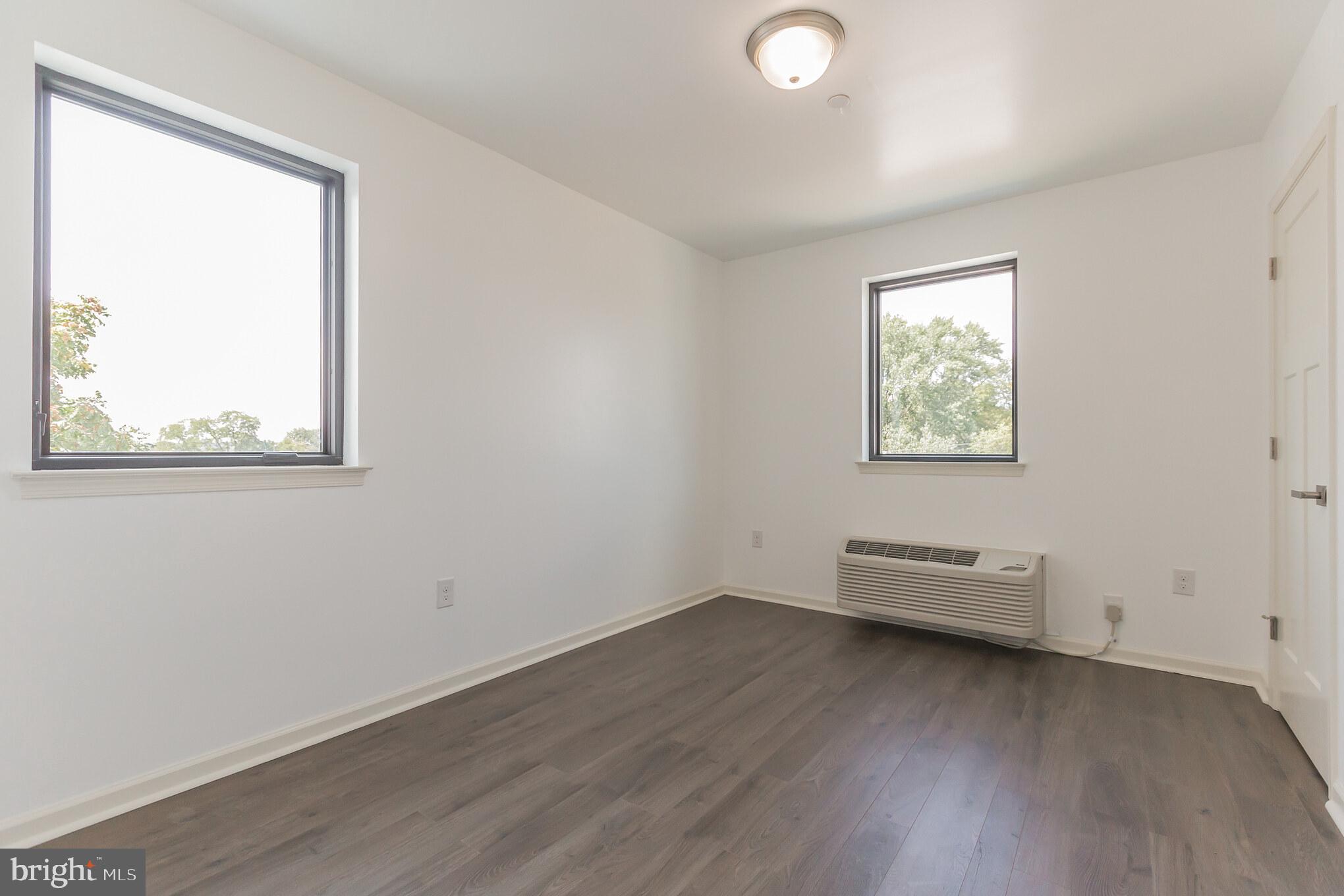 6778 Ridge Avenue, Unit 201 Philadelphia, PA 19128 - Photo 11 of 15 a view of a room with wooden floor and windows
