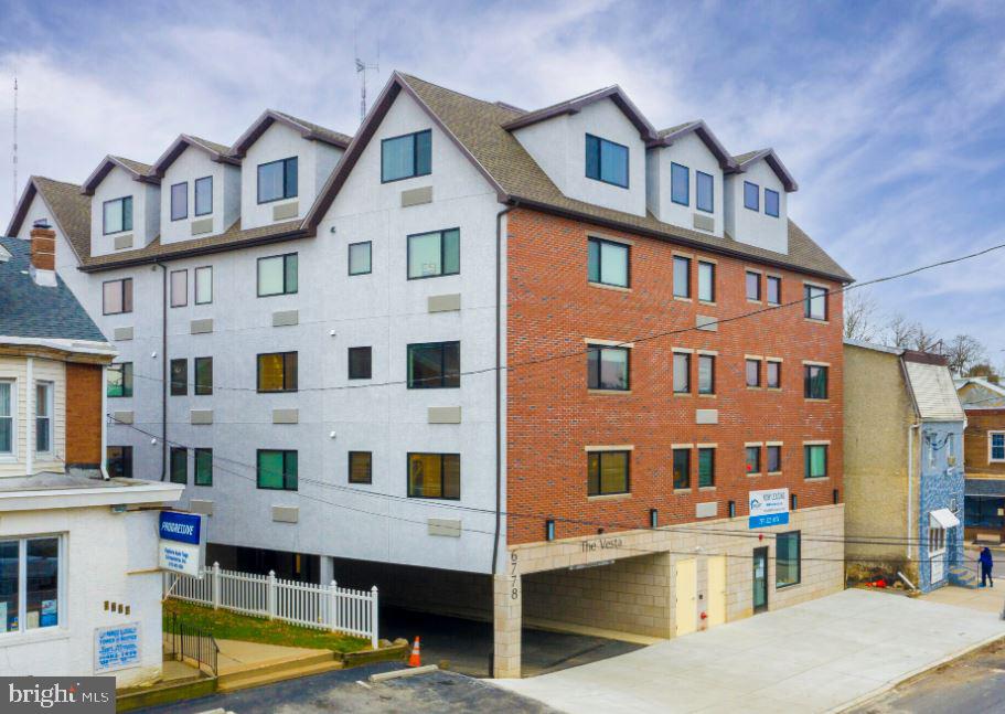 6778 Ridge Avenue, Unit 201 Philadelphia, PA 19128 - Photo 15 of 15 a view of a building with a swimming pool