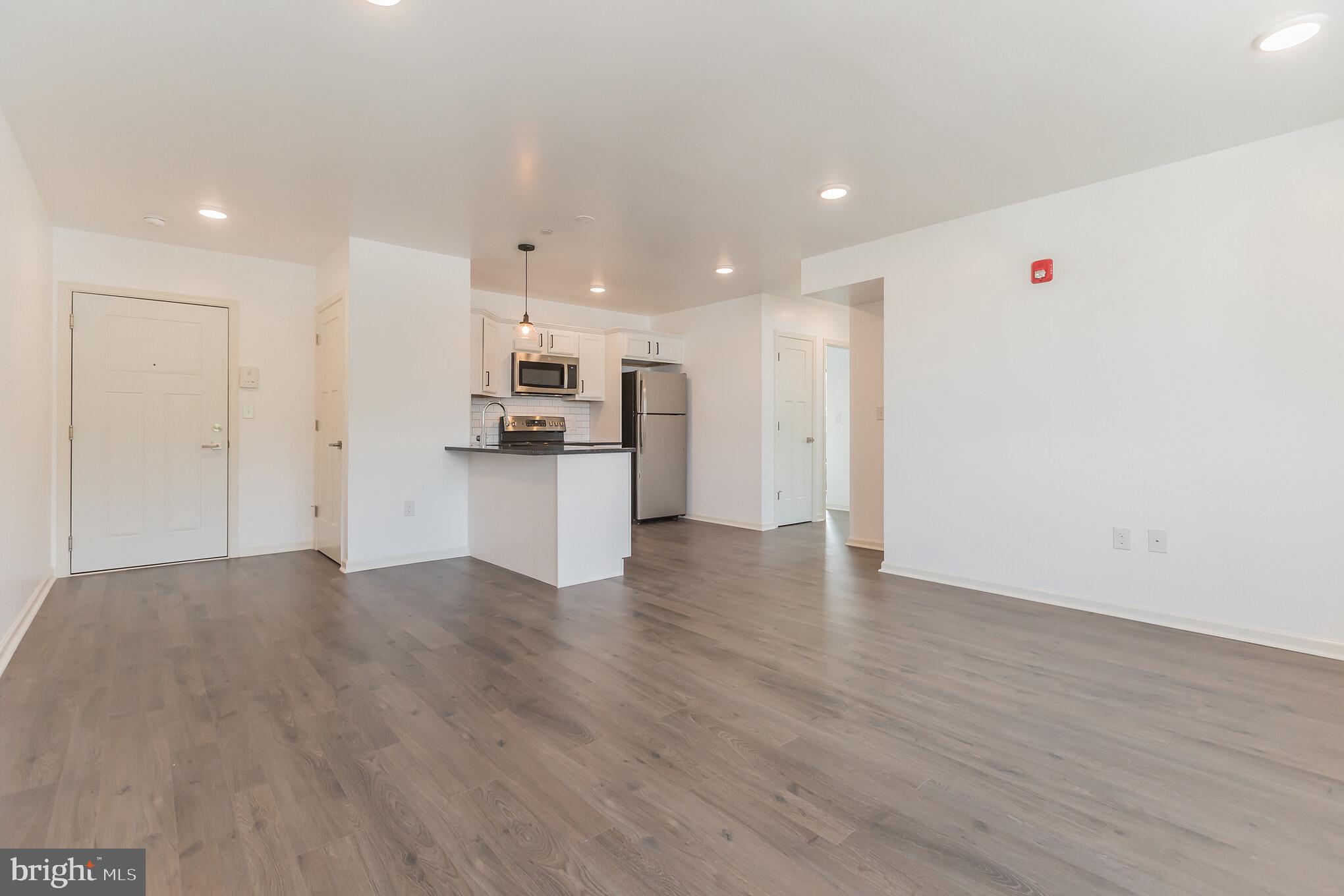 6778 Ridge Avenue, Unit 201 Philadelphia, PA 19128 - Photo 4 of 15 a view of a kitchen with a sink and wooden floor