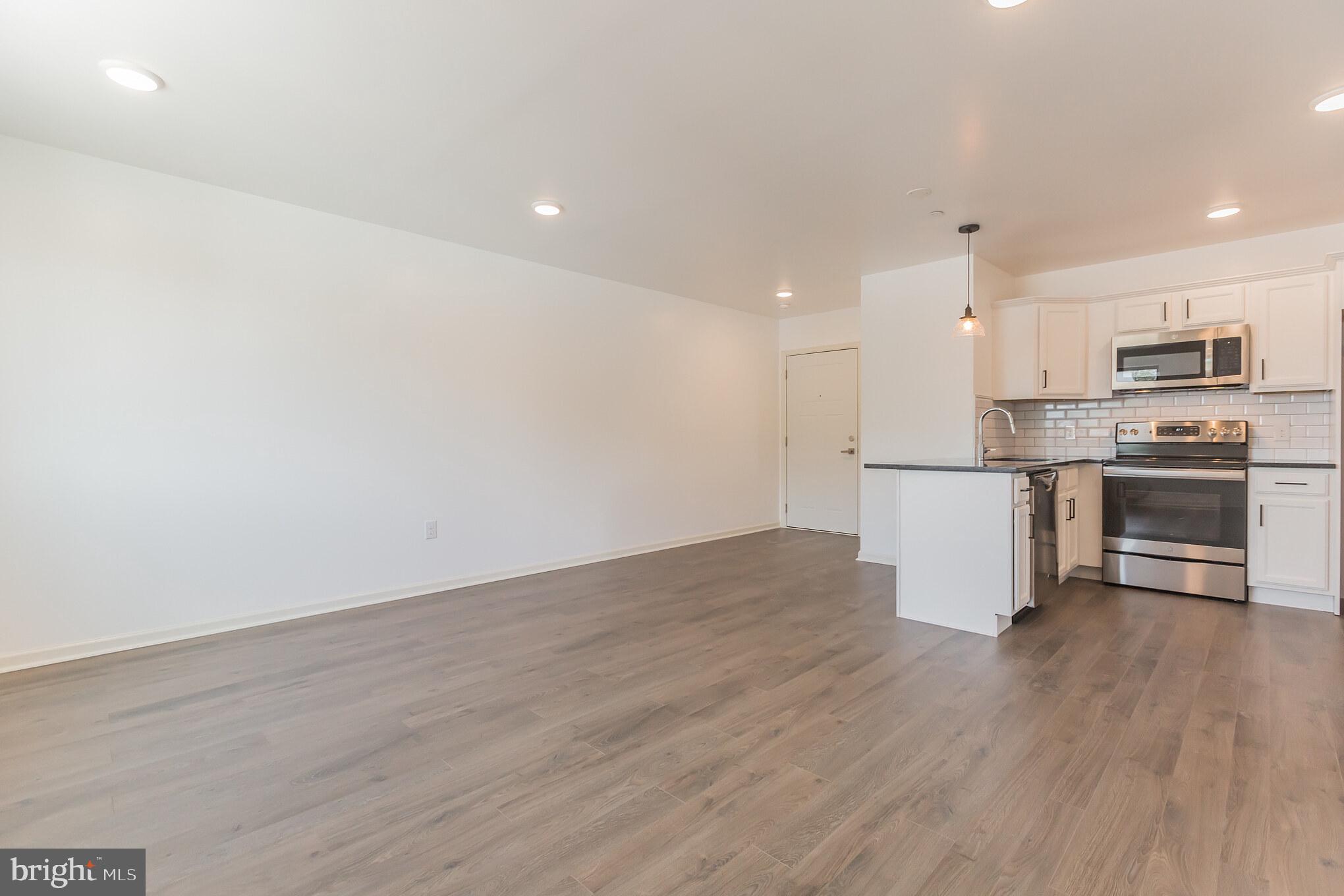 6778 Ridge Avenue, Unit 201 Philadelphia, PA 19128 - Photo 5 of 15 a view of kitchen with wooden floor and electronic appliances