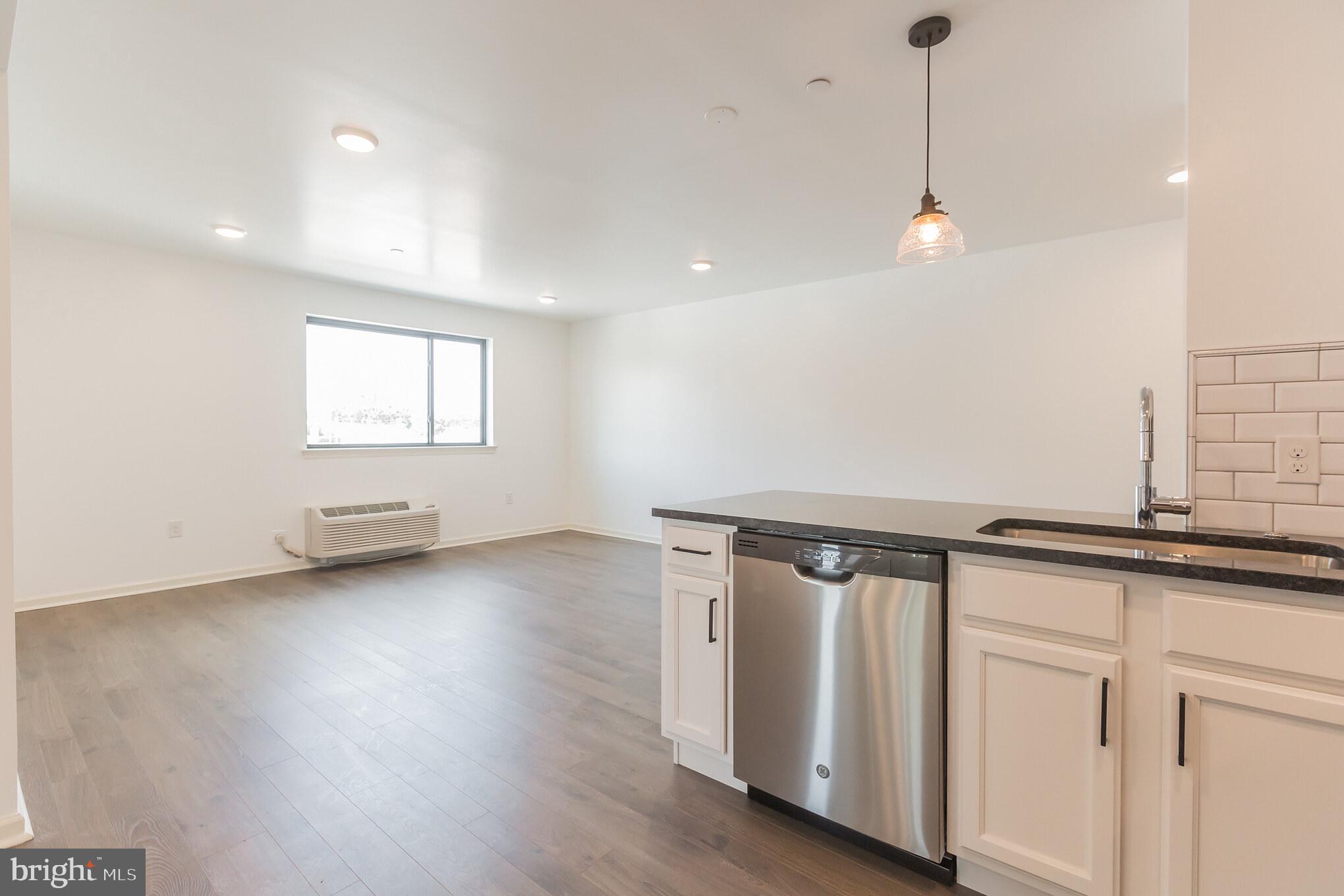 6778 Ridge Avenue, Unit 201 Philadelphia, PA 19128 - Photo 7 of 15 a view of a room with wooden floor and white walls