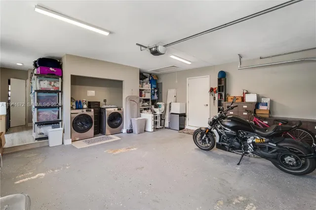 a dining room with furniture and a floor to ceiling window