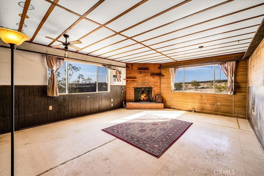 64720 Sonora Road Joshua Tree, CA 92252 - Photo 16 of 33 a view of a room with wooden floor and windows