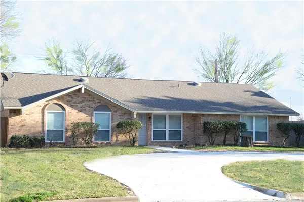 a front view of a house with a garden and porch