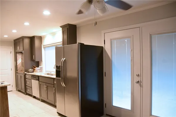 a modern kitchen with stainless steel appliances granite countertop a refrigerator and a sink