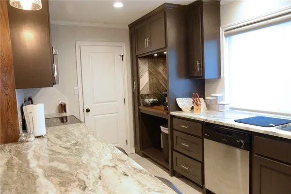 a kitchen with a sink appliances and cabinets