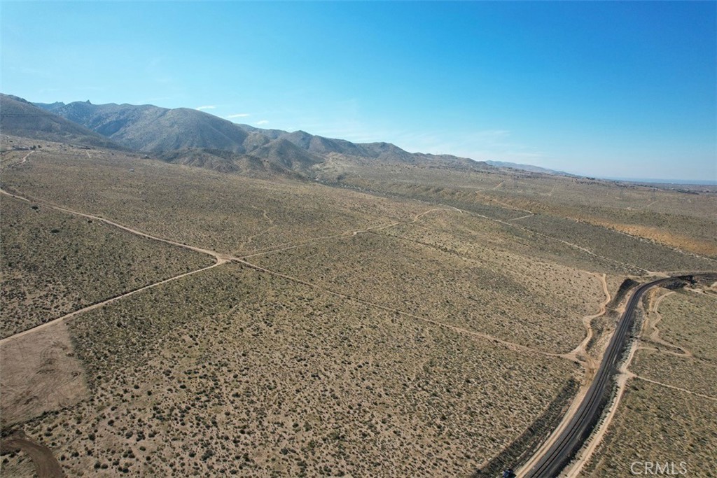 39 Santa Rosa Road Lucerne Valley, CA 92356 - Photo 13 of 18 a view of a dry yard with mountain