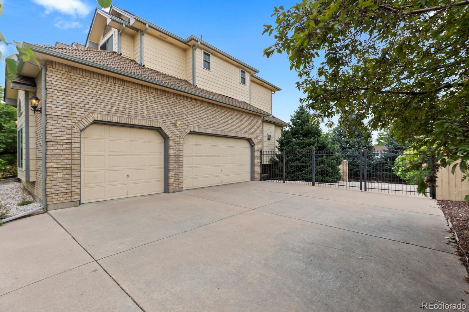 3900 Pierson Street Wheat Ridge, CO 80033 - Photo 35 of 39 a front view of a house with a yard and garage