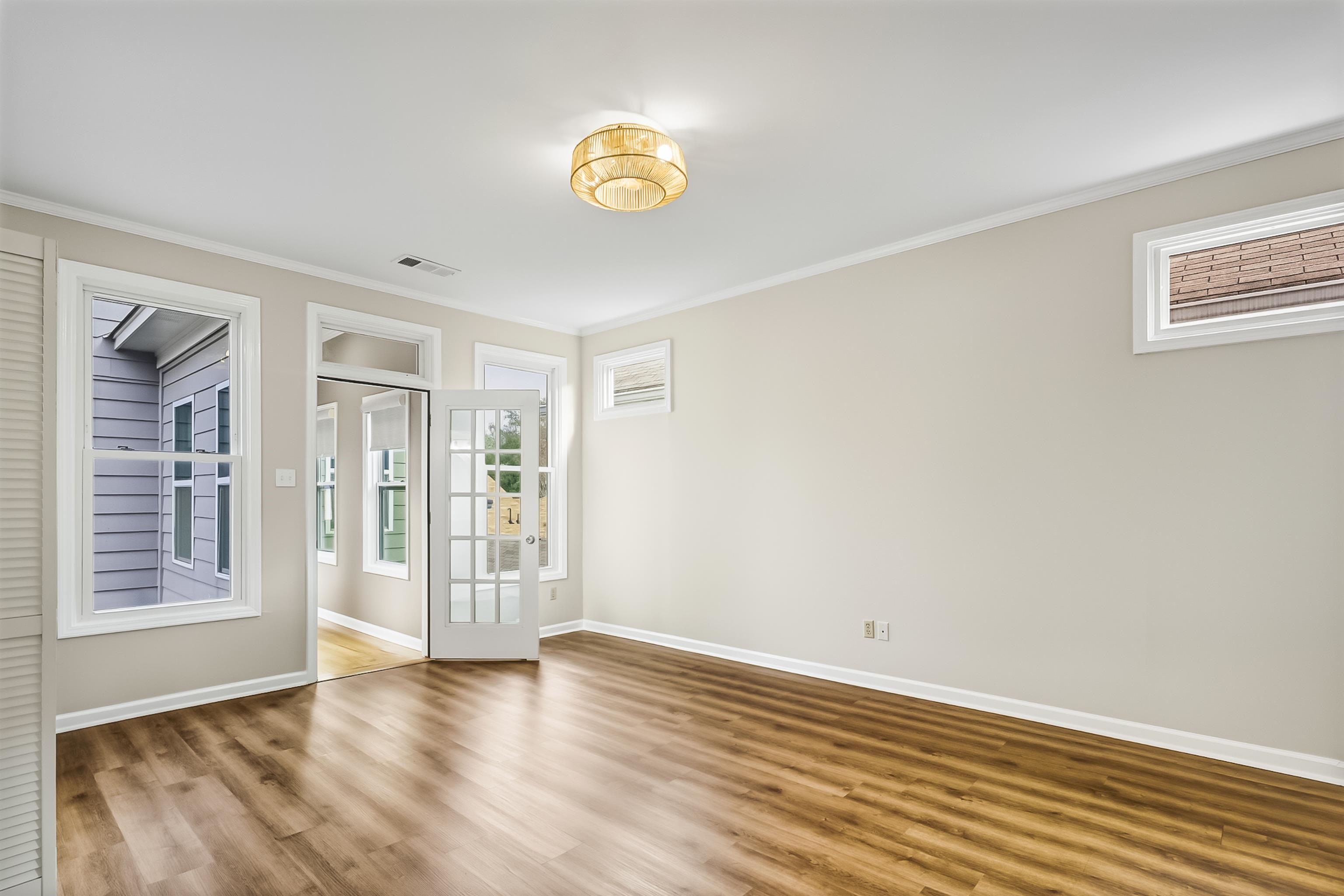 154 Harbor Ridge Lane North Memphis, TN 38103 - Photo 20 of 39 a view of an empty room with a window and wooden floor