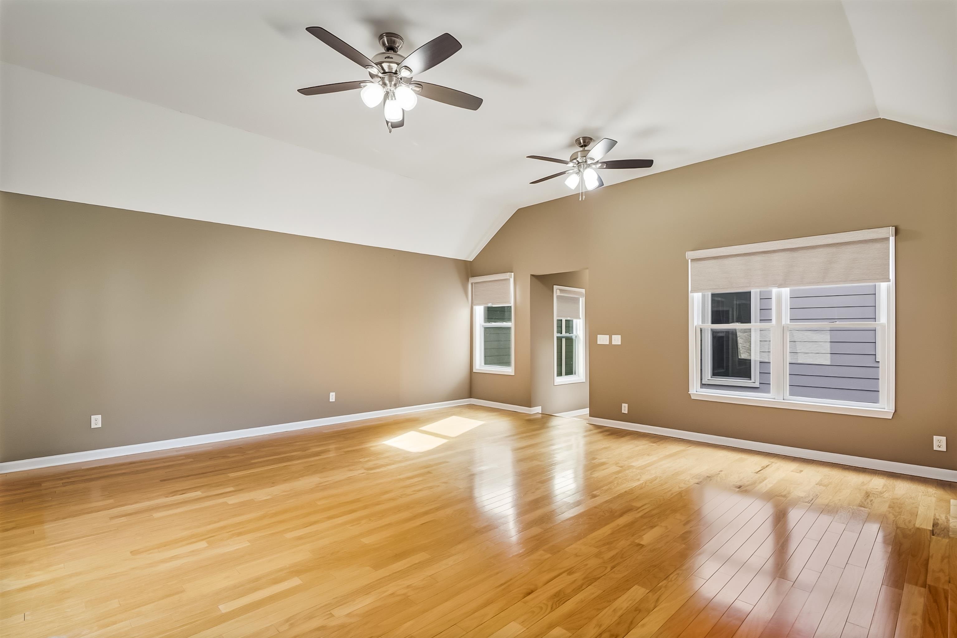154 Harbor Ridge Lane North Memphis, TN 38103 - Photo 25 of 39 a view of an empty room with chandelier fan and wooden floor