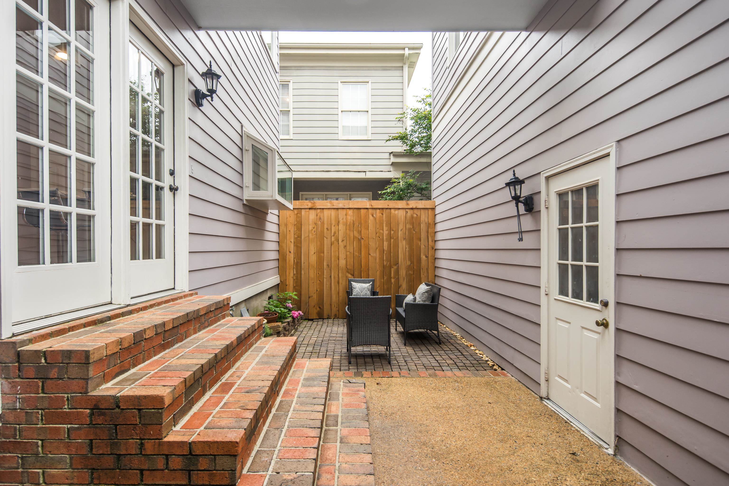 154 Harbor Ridge Lane North Memphis, TN 38103 - Photo 35 of 39 a view of a patio with a table and chairs and floor to ceiling window