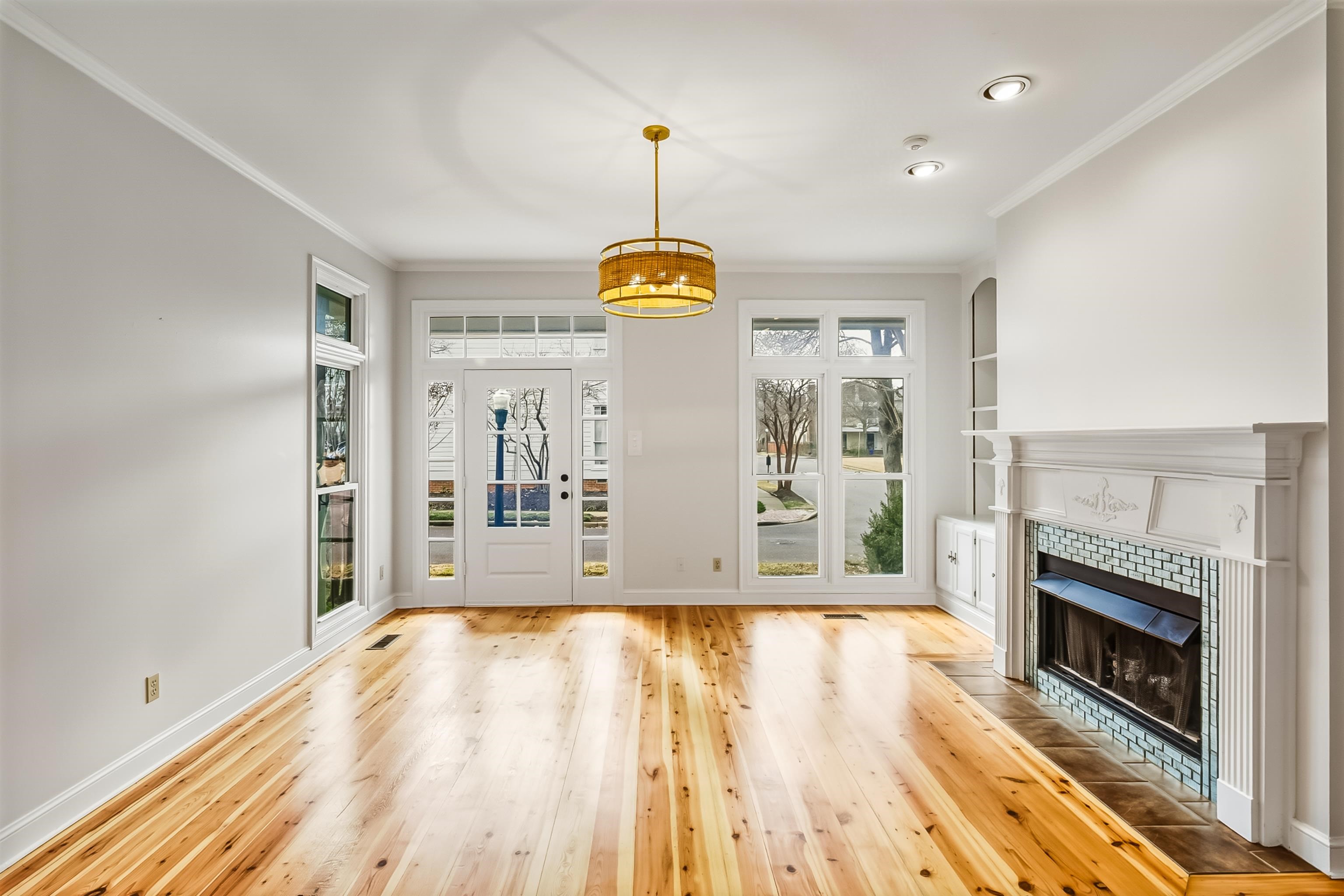 154 Harbor Ridge Lane North Memphis, TN 38103 - Photo 9 of 39 a view of empty room with wooden floor and fireplace