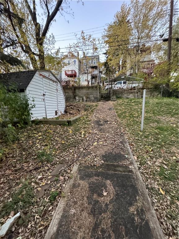 233 Alries Street Pittsburgh, PA 15210 - Photo 15 of 16 a backyard of apartments with large trees