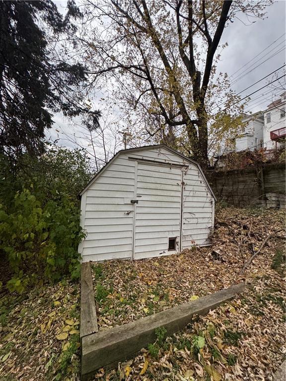 233 Alries Street Pittsburgh, PA 15210 - Photo 16 of 16 a view of a house with a yard and large tree