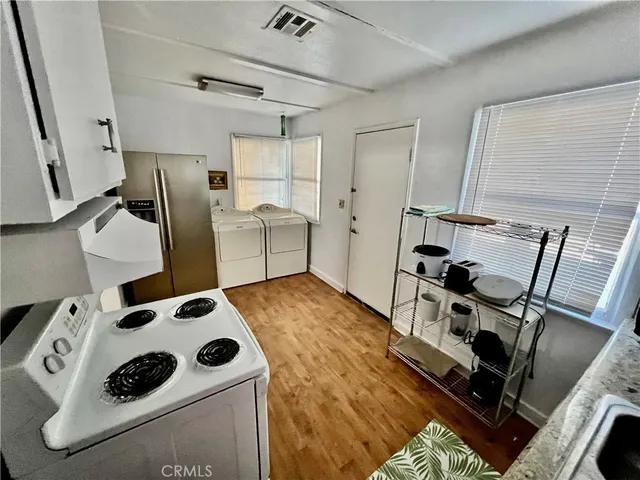 a kitchen with a refrigerator and a stove