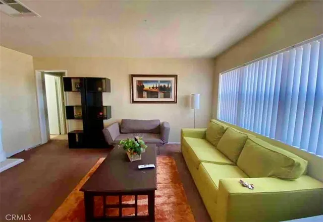 a living room with furniture and a lamp