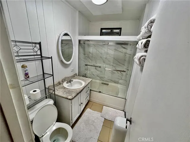 a bathroom with a toilet a sink and a shower