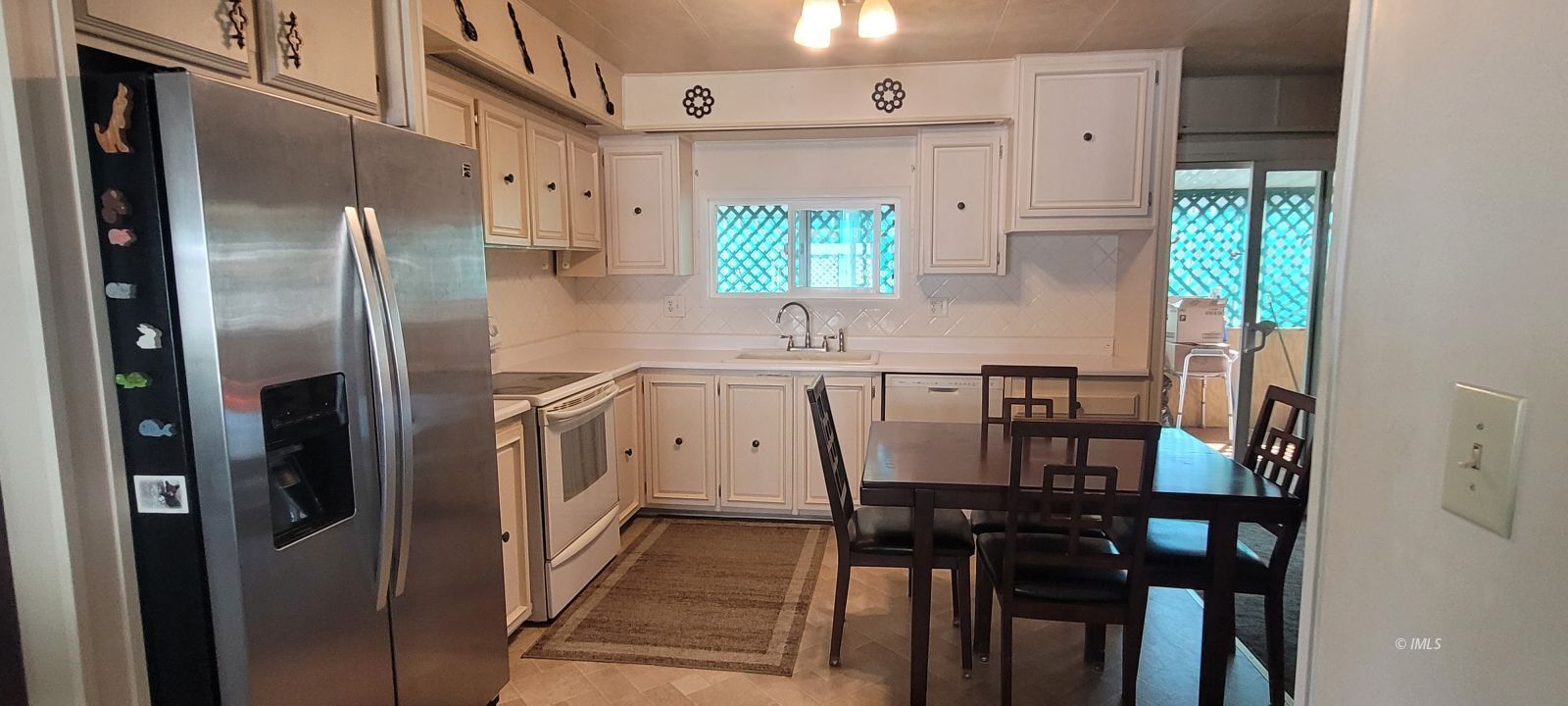 2293 Galloway Avenue Bishop, CA 93514 - Photo 4 of 13 a kitchen with stainless steel appliances a refrigerator and a window