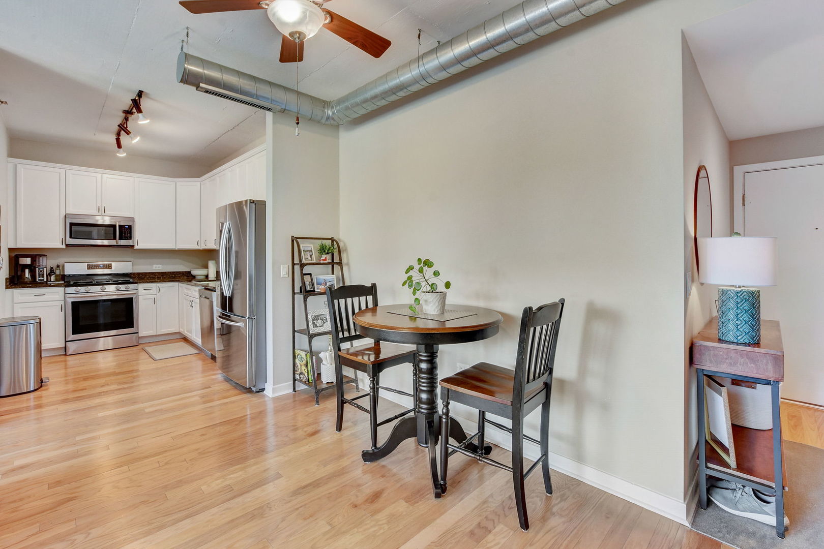 909 West Washington Boulevard, Unit 704 Chicago, IL 60607 - Photo 11 of 36 a view of a dining room with furniture wooden floor and chandelier